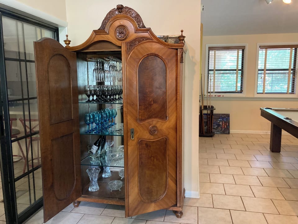 Wine Cabinet located in Den. 
Plenty of wine glasses etc.