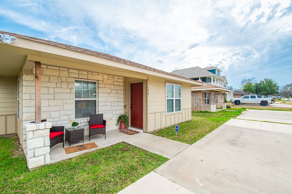 A cozy front porch to welcome friends and plenty of parking plus an RV plug!