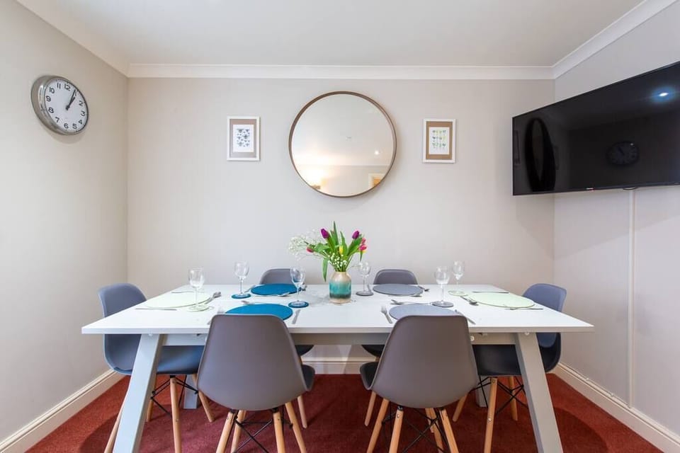 The dining area with a wall-mounted television.