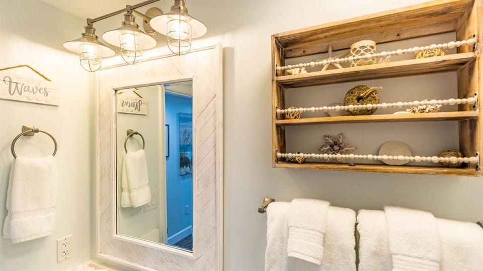 The third bathroom is right outside the second guest room in the hallway