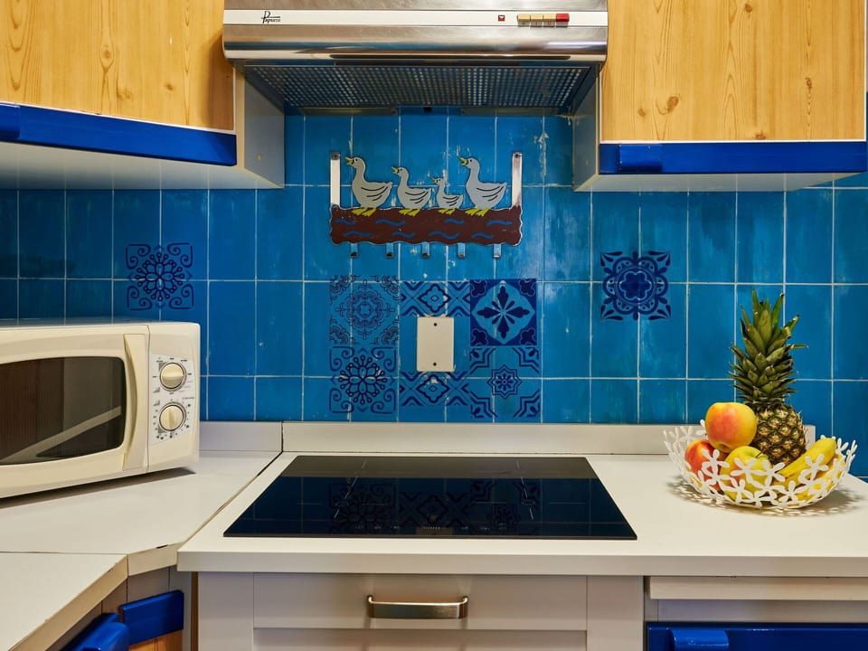 Blue, Kitchen, Cabinetry, Azure, Countertop, Interior Design, Building, Yellow, Wall, Floor