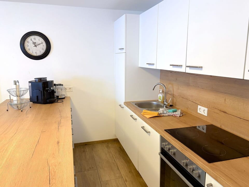 Countertop, Kitchen, Furniture, Cabinetry, Flooring, Interior Design, Kitchen Appliance, Floor, Wood, Major Appliance
