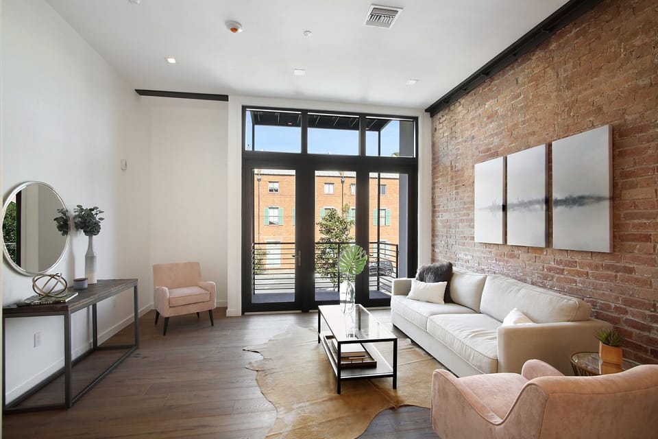 Turnkey and designer furnished with spacious living area and exposed brick. 