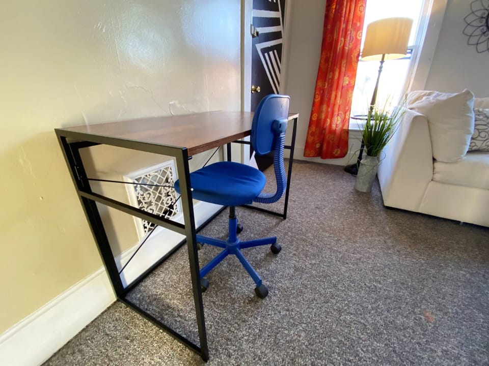 Portable desk and swivel chair at the ready for those who work from home.