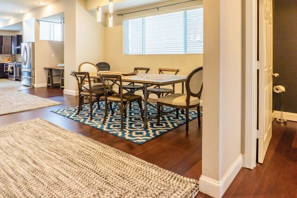 A large dining room table where you can serve meals for the whole family. - Upper Townhouse
