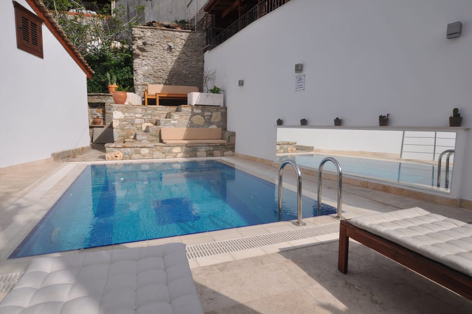 Private swimming pool with sun loungers and terraces
