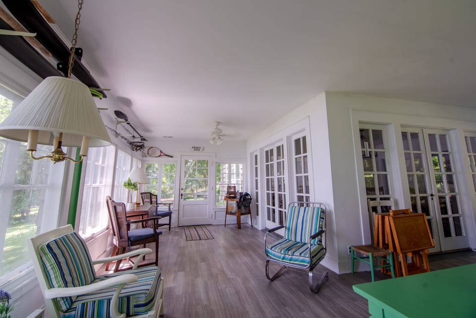 Fully enclosed porch with numerous windows for enjoying the lake breeze.