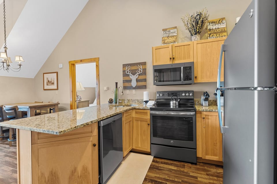 Full kitchen featuring stainless steel appliances, and breakfast bar for casual dining.