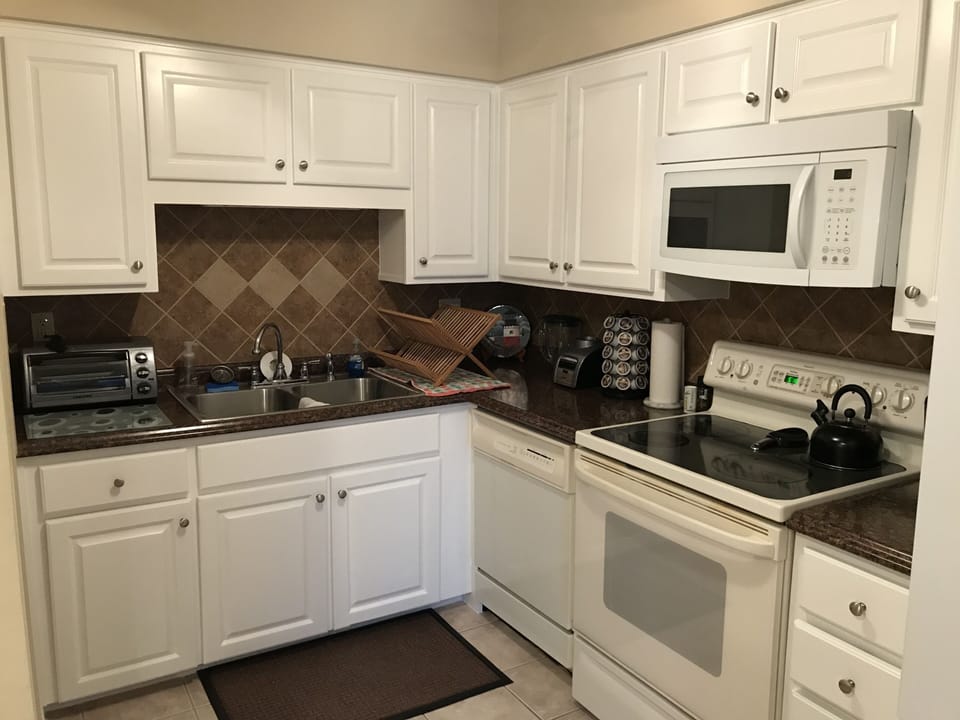 Range, oven, microwave, toaster oven, Keurig with coffee, and refrigerator