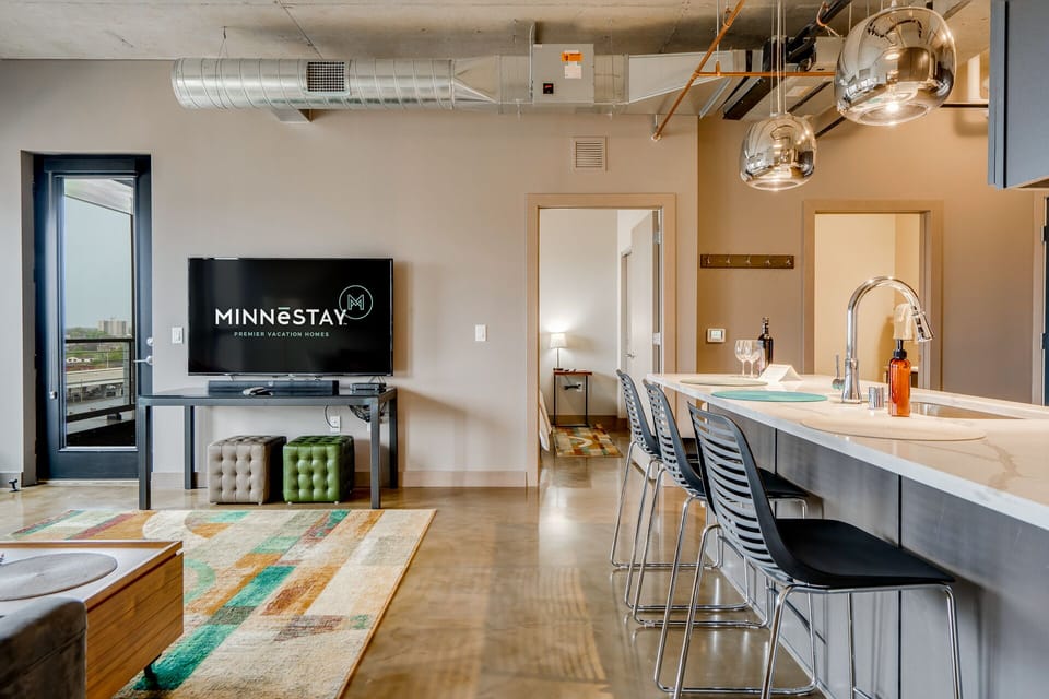 Your modern kitchen flows seamlessly into the living area, featuring sleek granite countertops and stylish pendant lighting perfect for morning coffee or evening entertaining.