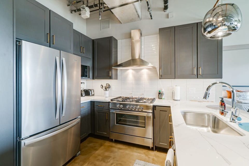 Your fully equipped kitchen features sleek stainless steel appliances, granite countertops, and modern cabinetry—perfect for creating memorable meals.