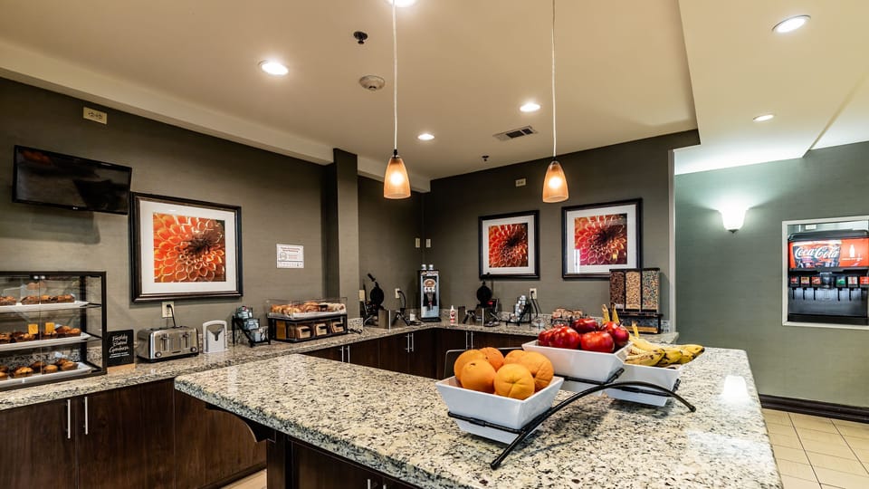 Help yourself to fresh fruit, baked goods, and drinks at the complimentary breakfast counter