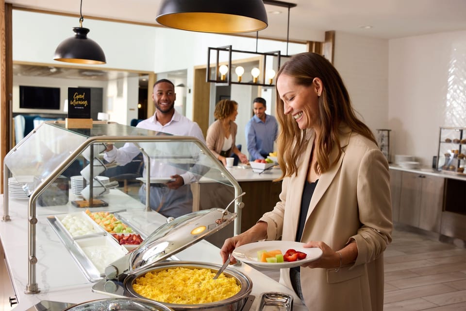 Start your day with a smile, enjoying a hearty breakfast buffet with friends.