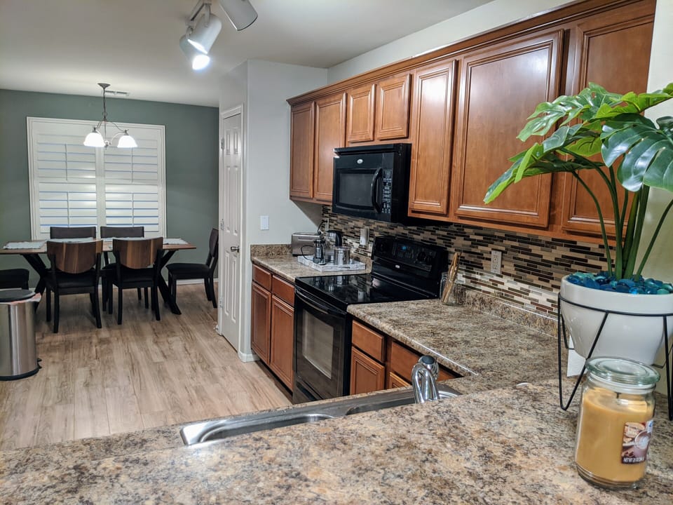 Complete kitchen for cooking with coffee pot and toaster, microwave, fridge. 