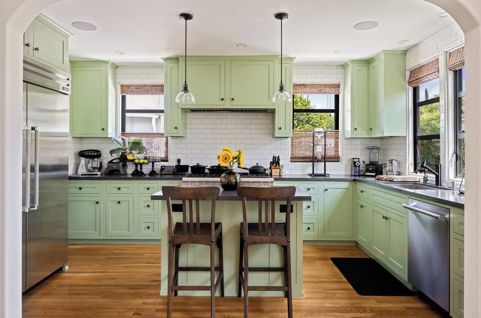 Chefs kitchen: 6 burner and griddle gas stove, 48" Thermador fridge, and island.