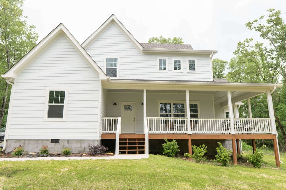 Front view of home with wrap around porch.