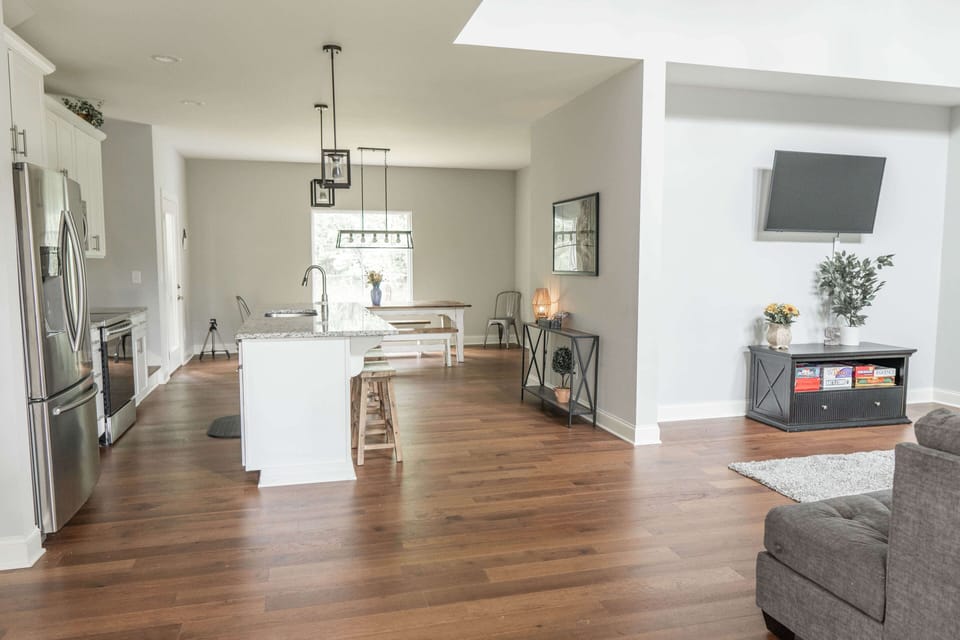 Kitchen from entryway and front door. Door to porch on left of kitchen table