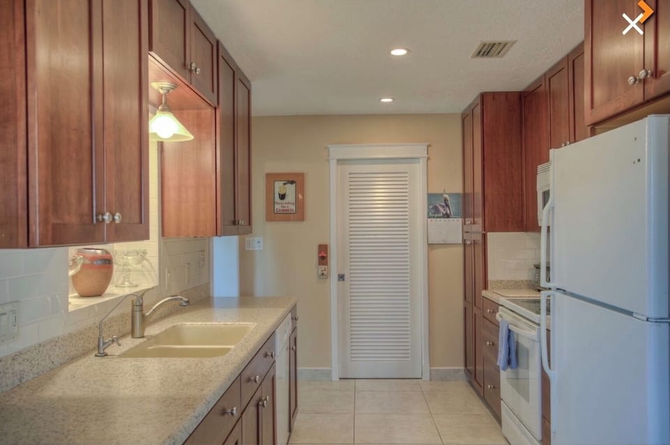 Kitchen and door to laundry.  Back bedroom door to the left  end of cabinets. 