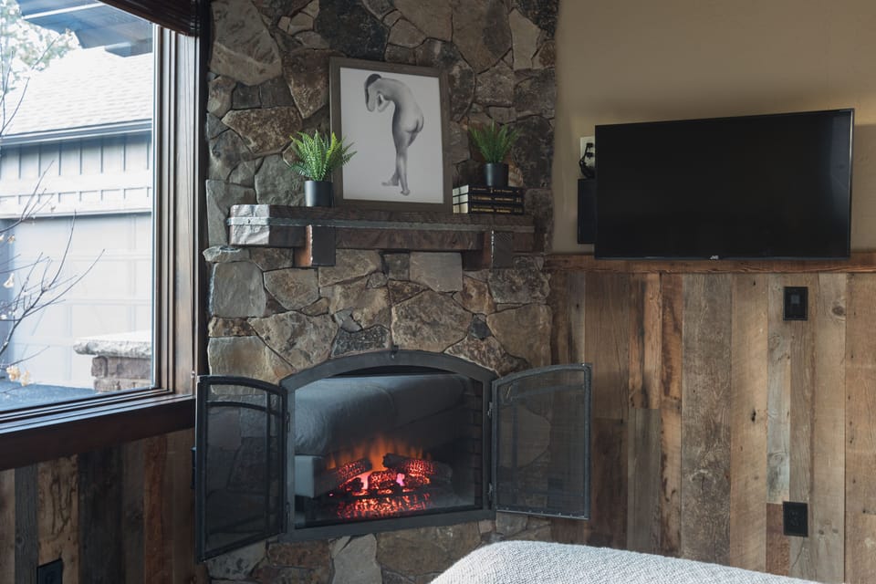 Bedroom 5 - fireplace and television.