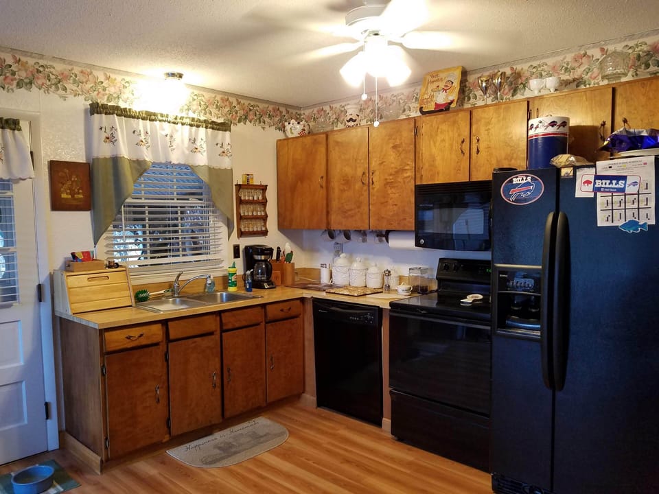 kitchen with stove, oven, coffee maker, toaster, refrig with ice maker, microwav