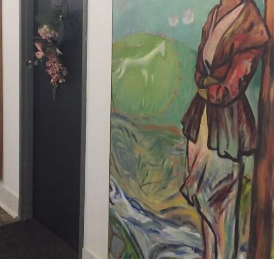 This is the door to your loft. Look for large paintings /seasonal swag on door 