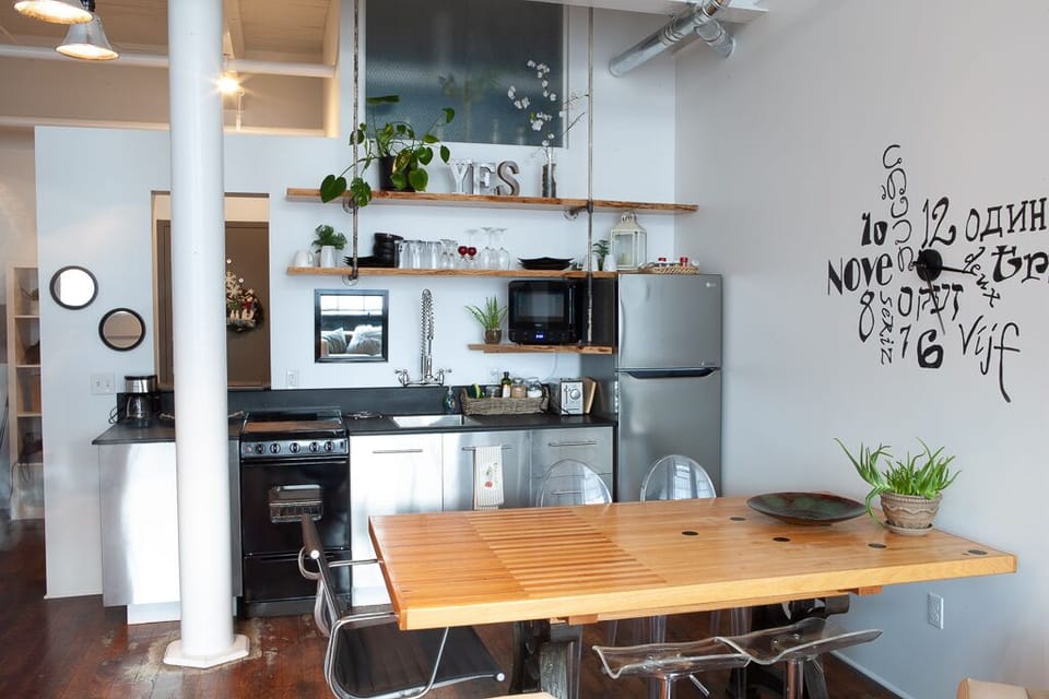 Kitchen with authentic bowling ally repurposed floor dining table 