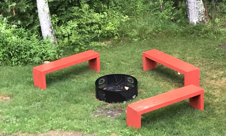 Fire pit with bench seating. Extra camp chairs for use