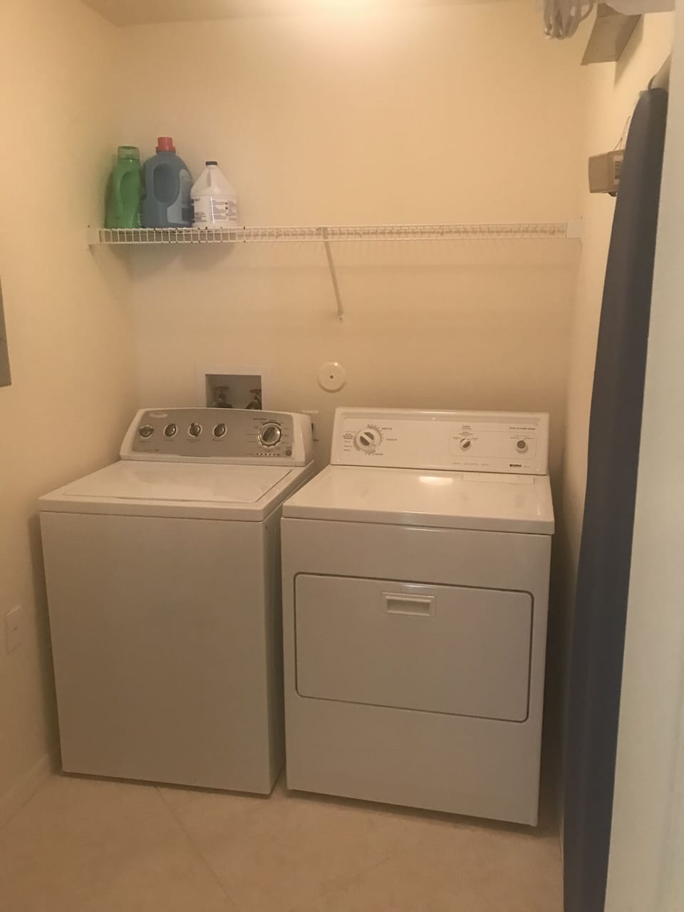 laundry room with washer, dryer, ironing board and iron
