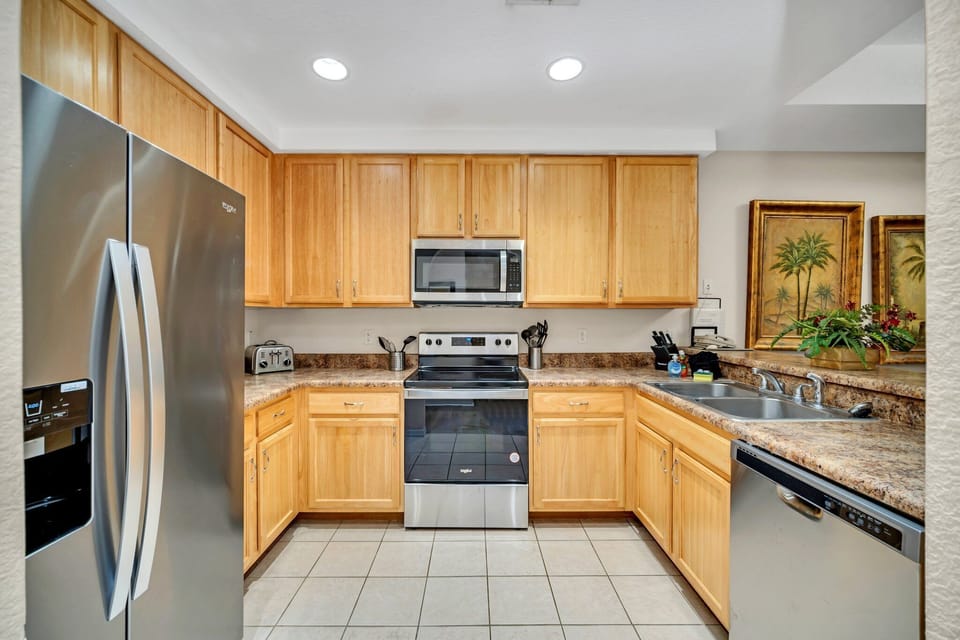 Stunning kitchen full of stainless steel appliances for family meals and entertaining.