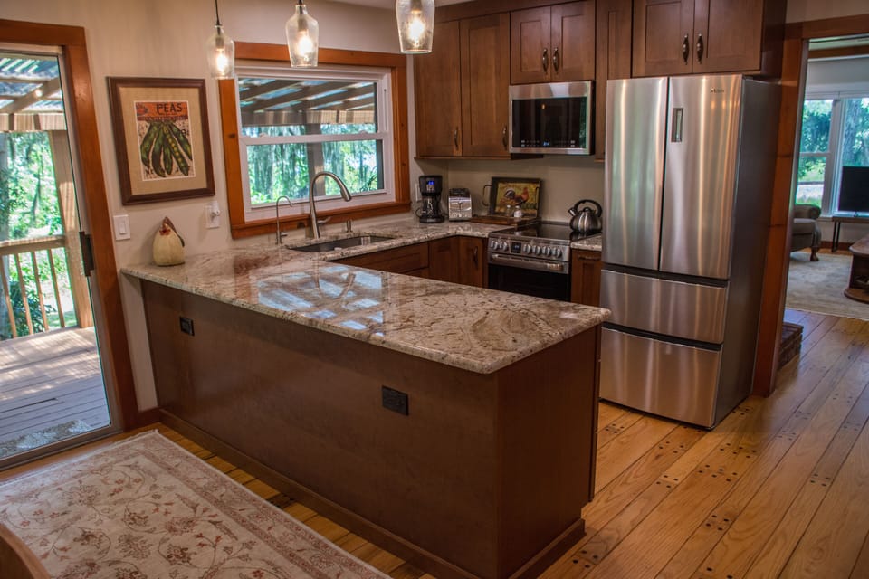 Kitchen area with sliding door to outside deck.
