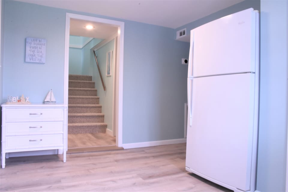 Lower level entry (2nd full fridge), stairs between upper and lower levels