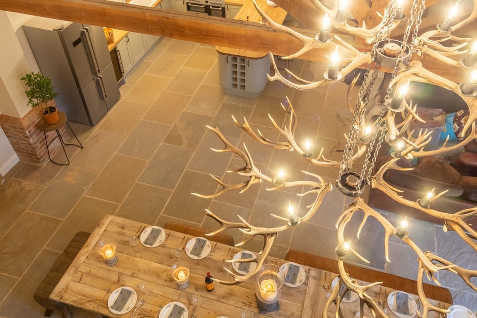 The Owl House: Dominated by a magnificent open plan living space and huge handmade table with impressive chandelier made with shed antlers