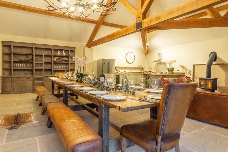 Hill Farm, Massingham: The Owl House: Dining table with view to kitchen and sitting room with log burning stove