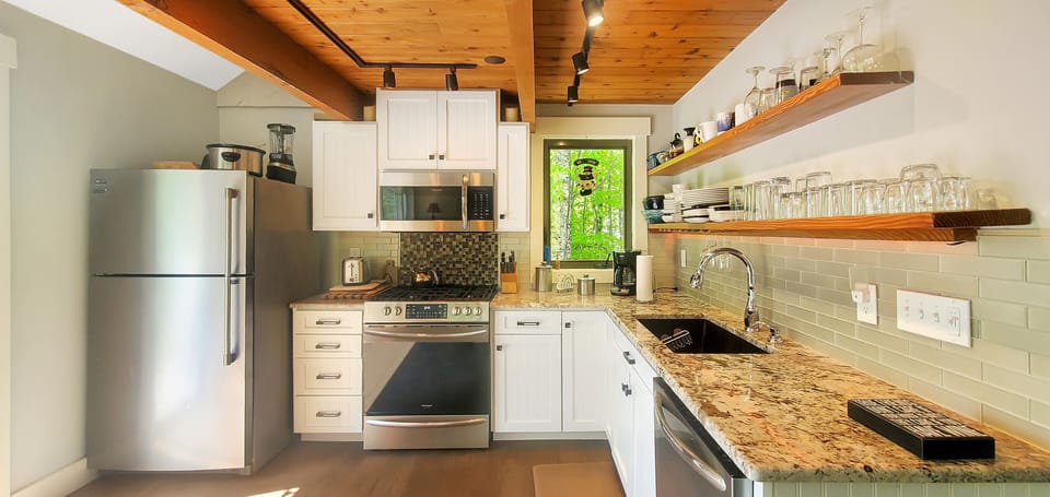 Full kitchen with gas range, microwave, dishwasher, and plenty of counter space.