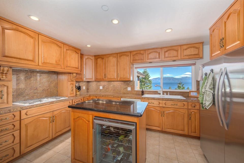 Kitchen features double oven, large refrigerator, 5 burner gas stove, microwave