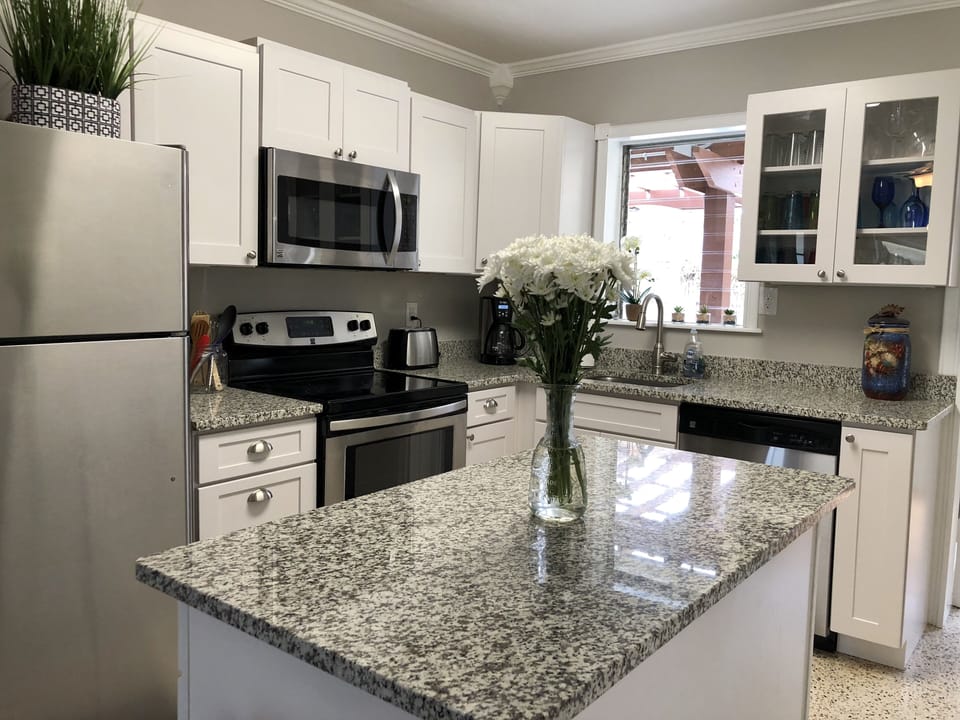 Newly renovated kitchen with granite countertops & stainless steel appliances