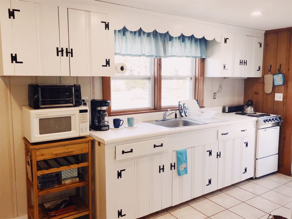 Kitchen has ceramic tile floor and ample cabinet storage