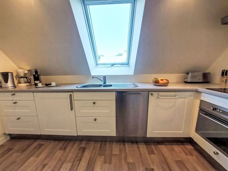 Flooring, Wood, Interior Design, Kitchen, Countertop, Floor, Cabinetry, Furniture, Major Appliance, Kitchen Appliance