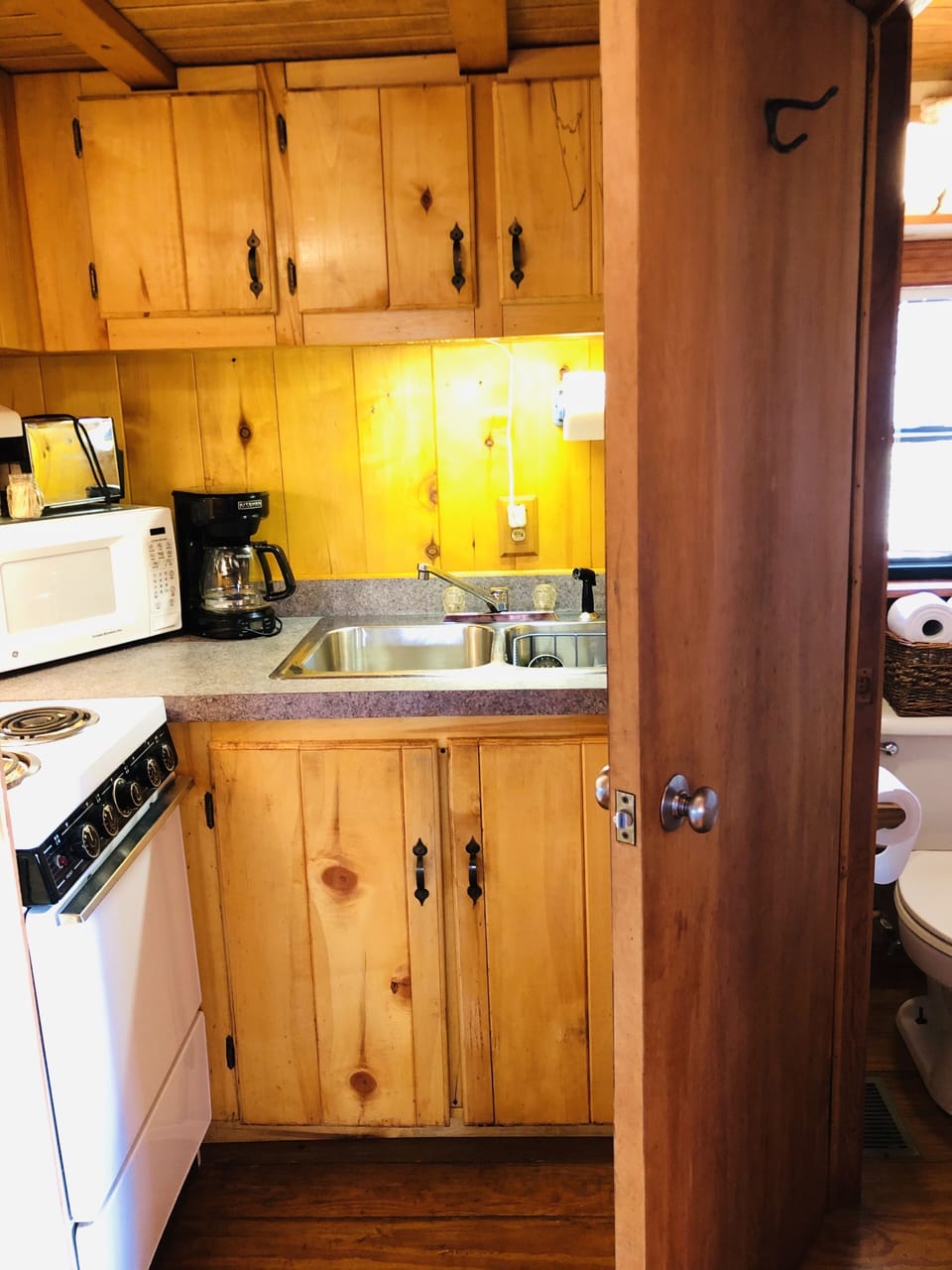 Bathroom is off of kitchen, away from sleeping area.