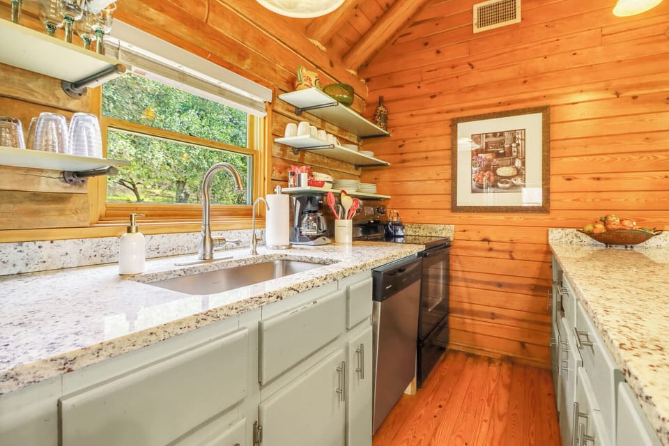 The large window over the sink has views of the back yard