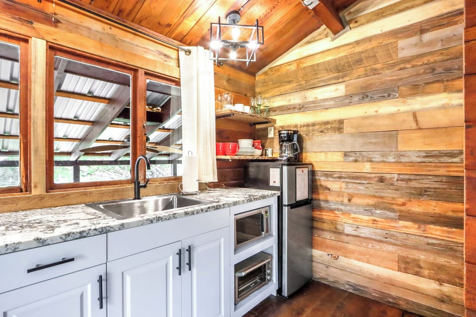 The kitchenette has a mini fridge, microwave, and toaster oven