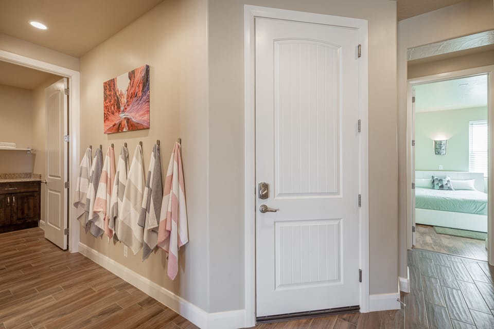 Hallway View - Garage door with bathroom on your left and room on your right.