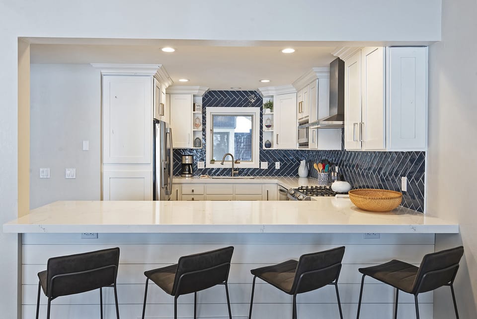 Fully Equipped Kitchen with Bar Seating for Four, Stone Countertops, and New Stainless Steel Appliances