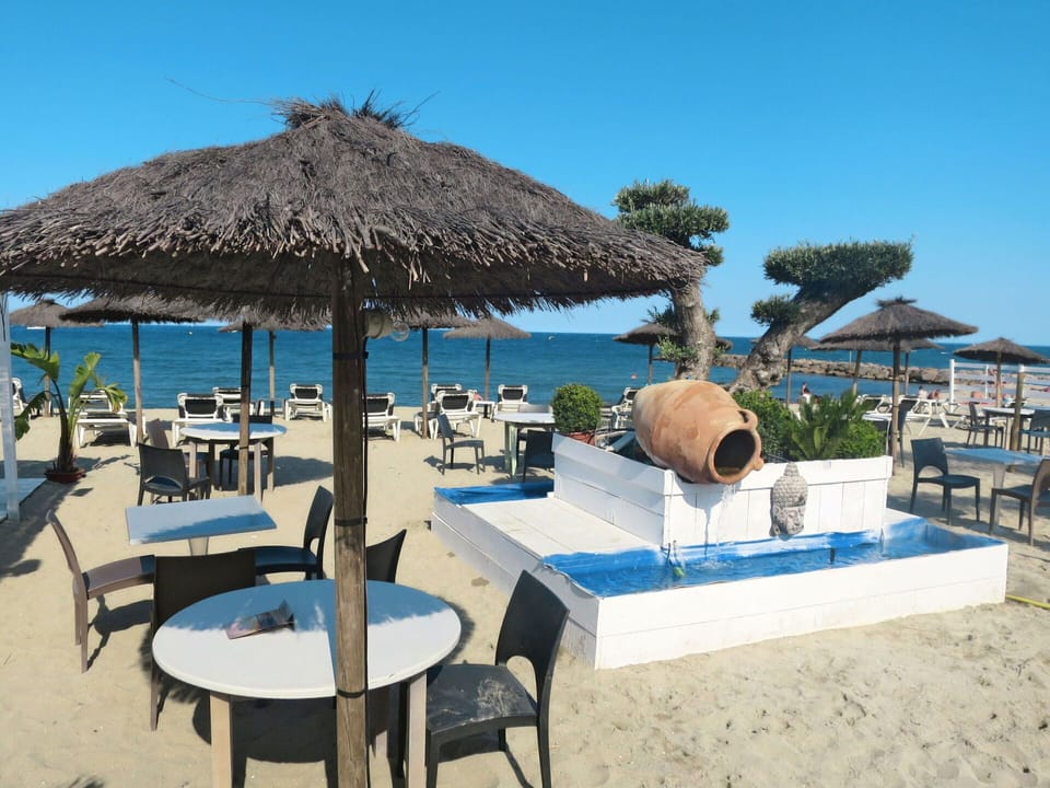 Sky, Property, Blue, Shade, Outdoor Furniture, Arecales, Beach, Table, Water, Tree