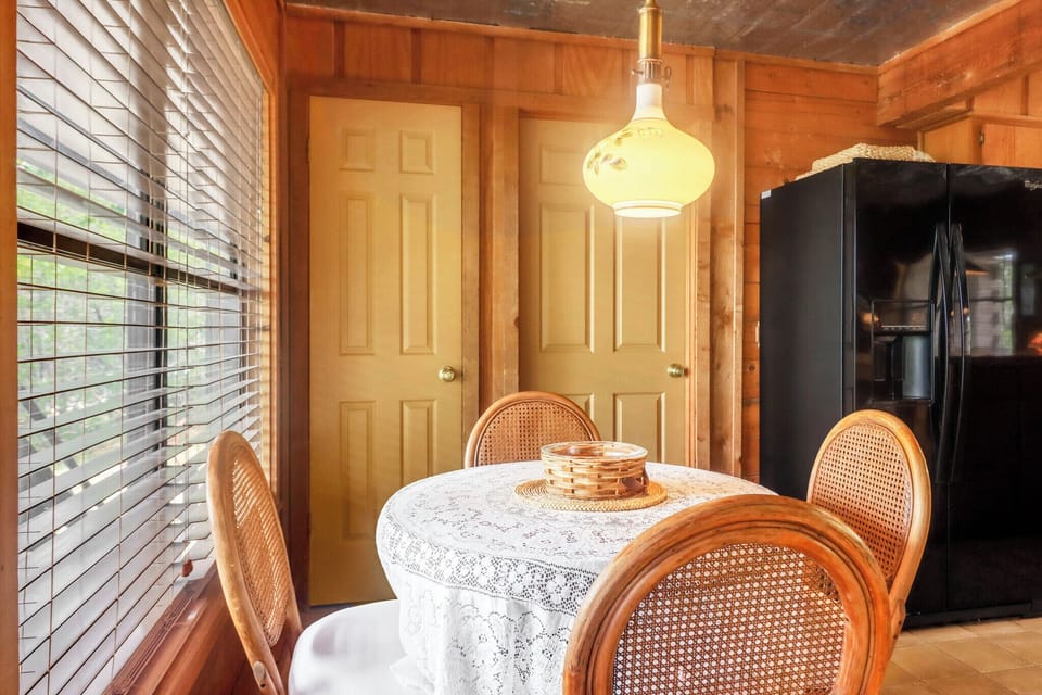Gather around this welcoming dining space with warm wood accents and natural light