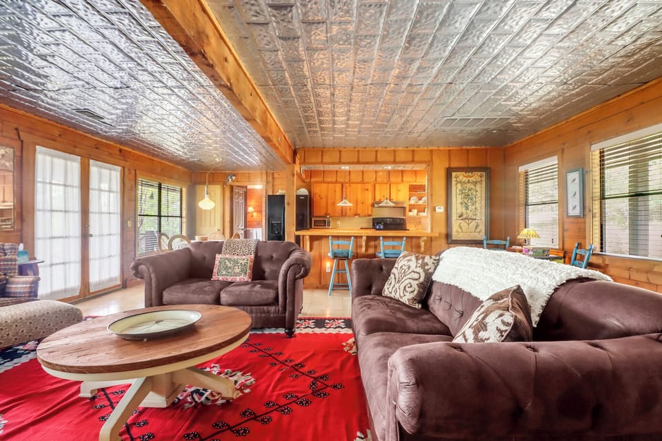 Unwind in your cozy living room with plush sofas and warm wood finishes, then step into the open kitchen to whip up your favorite meals