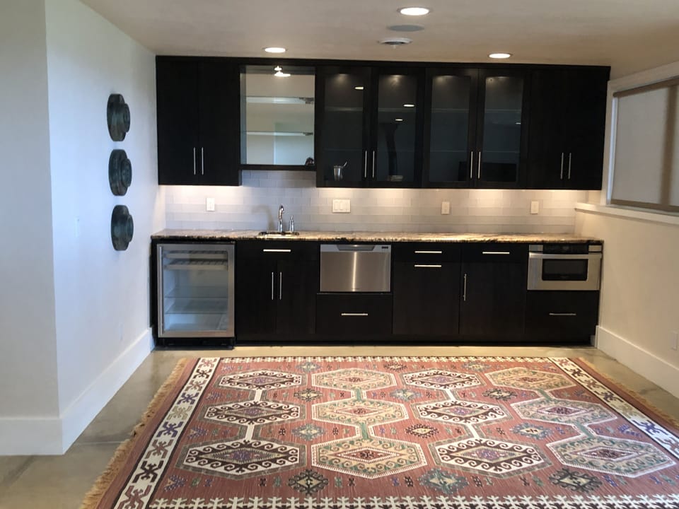 Kitchenette includes beverage refrigerator, dishwasher drawer and microwave

