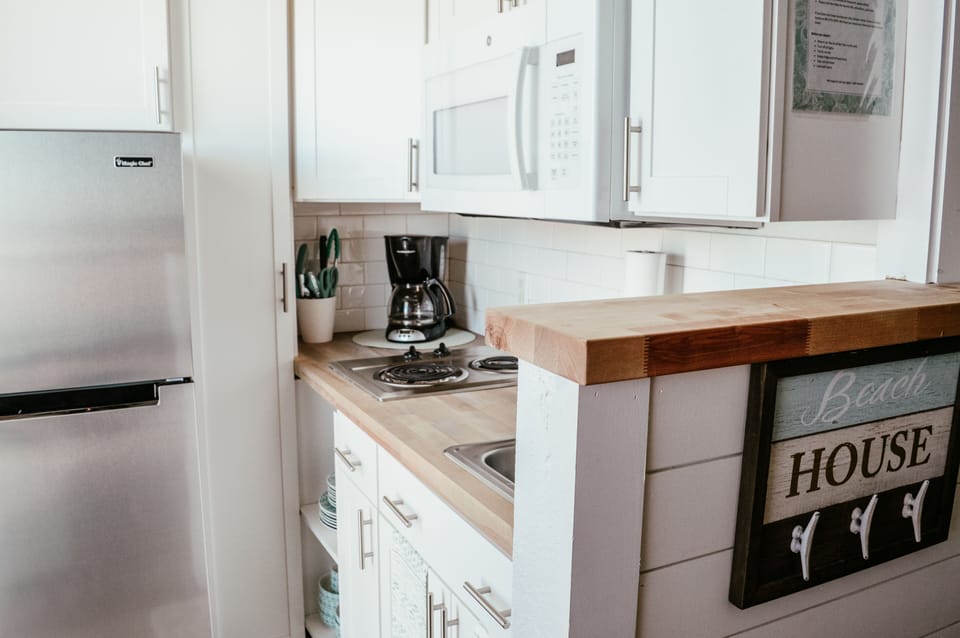 Well appointed kitchen with many utensils and small appliances.