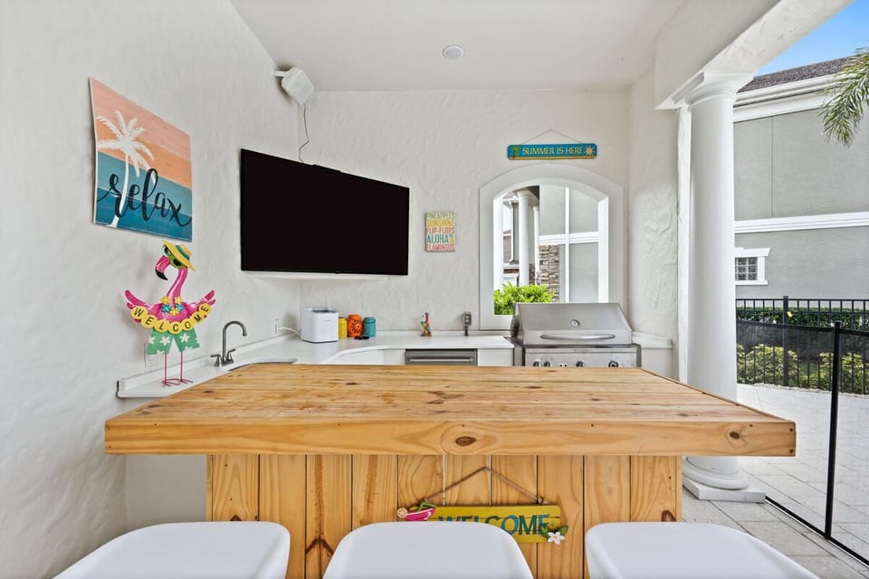 Summer kitchen with 70" TV & bar