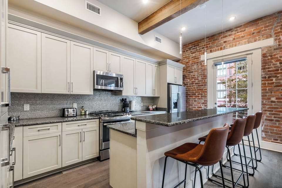 Cook and dine easily in the fully stocked kitchen, equipped with all stainless steel appliances, gas range, basic cookware, and a dining area for a comfortable meal at home. Entertain at the bar with seating for four.